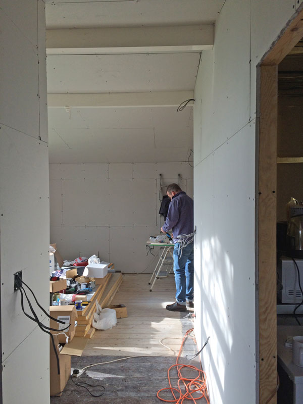 The view from the door, all plasterboarded and first fixed. Behind Jon will be a library/study area.